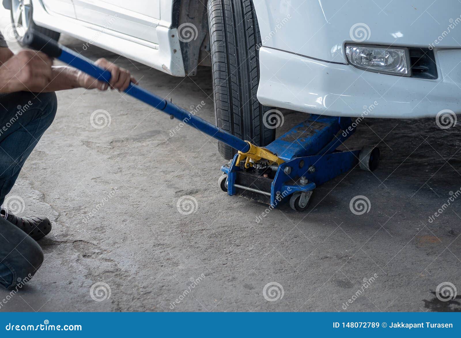 Hydraulic Car Jack To Lift Car For Check The Wheel Stock Image