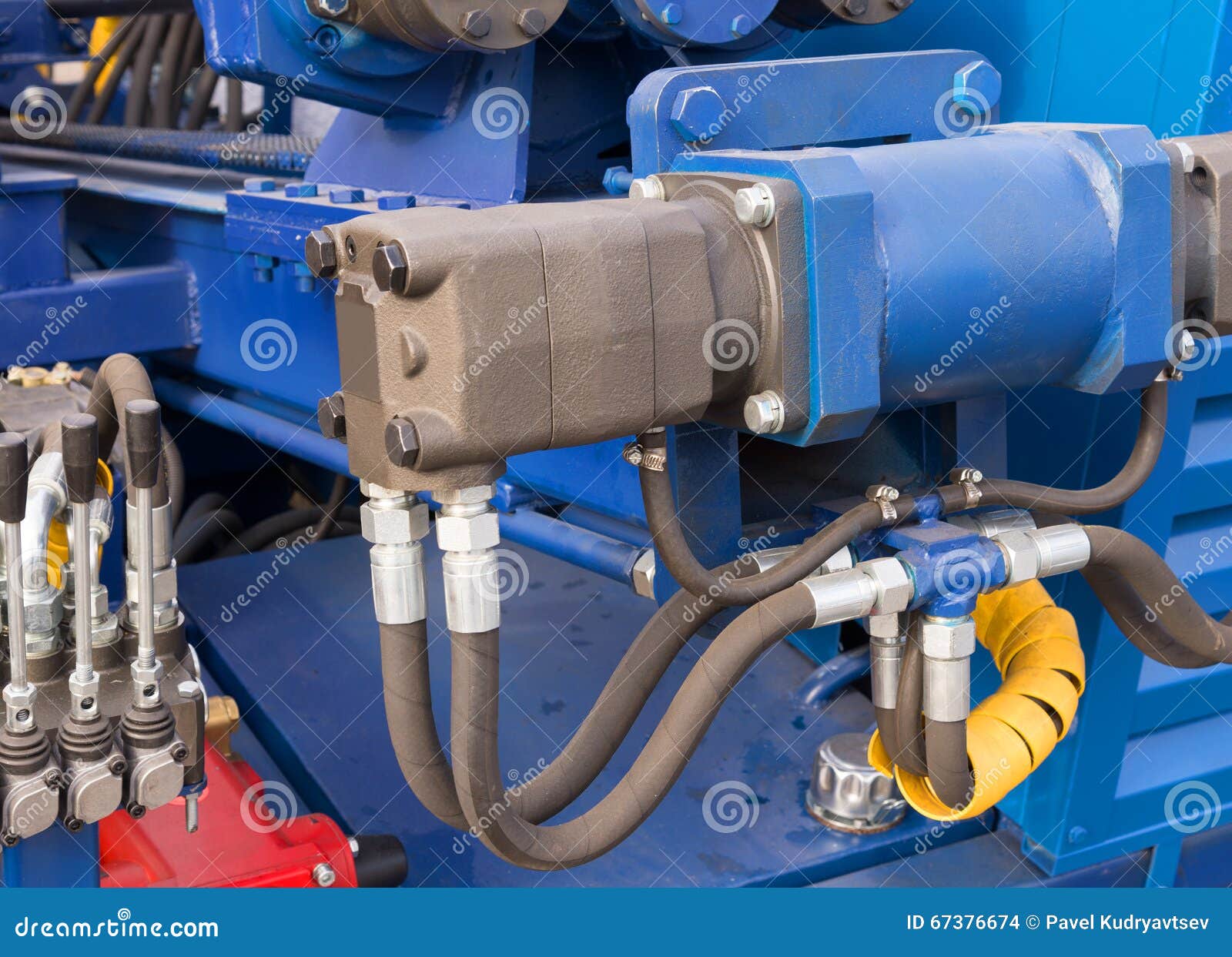 Hydraulic Tubes, Fittings and Levers on Control Panel Stock Photo