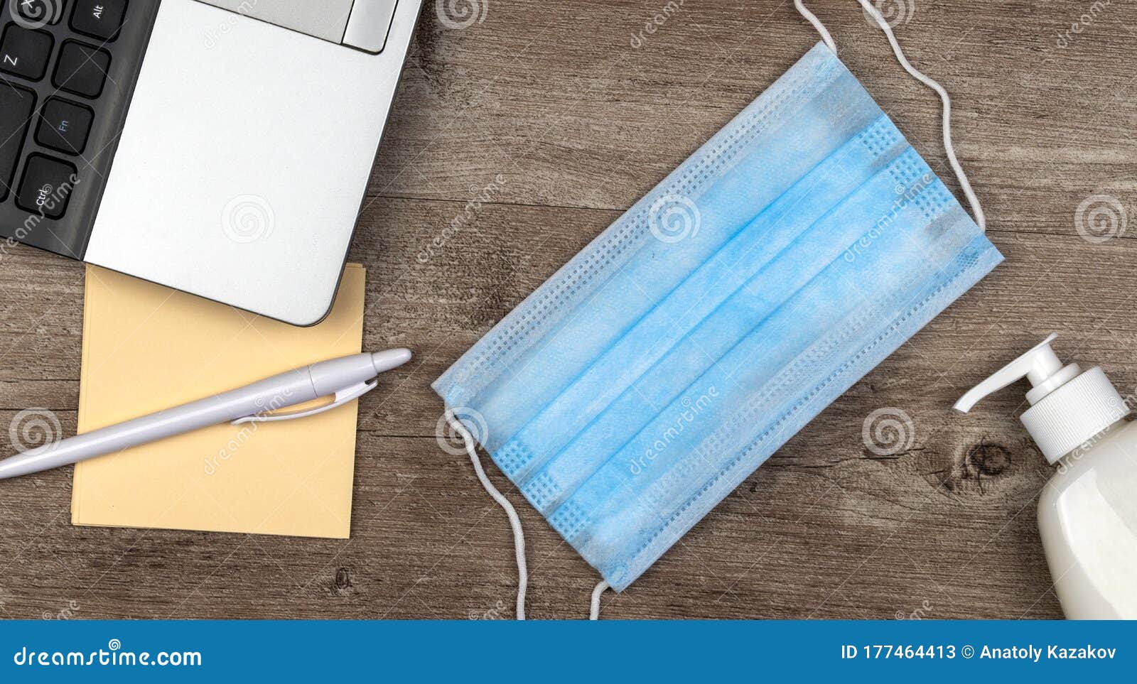 hygiene in the office. remote work kit on wooden desk. sanitizer gel and face mask