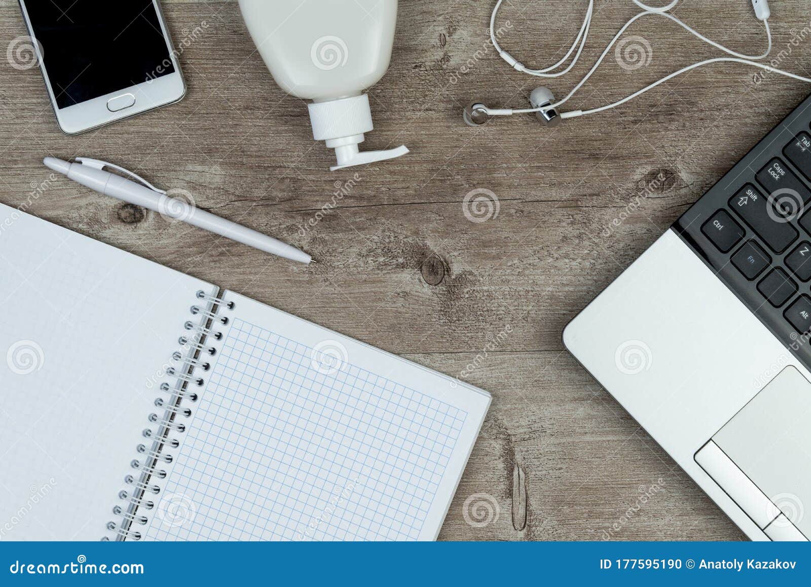 hygiene in the office. top view close up of office desk, desktop with laptop, phone and medical face mask