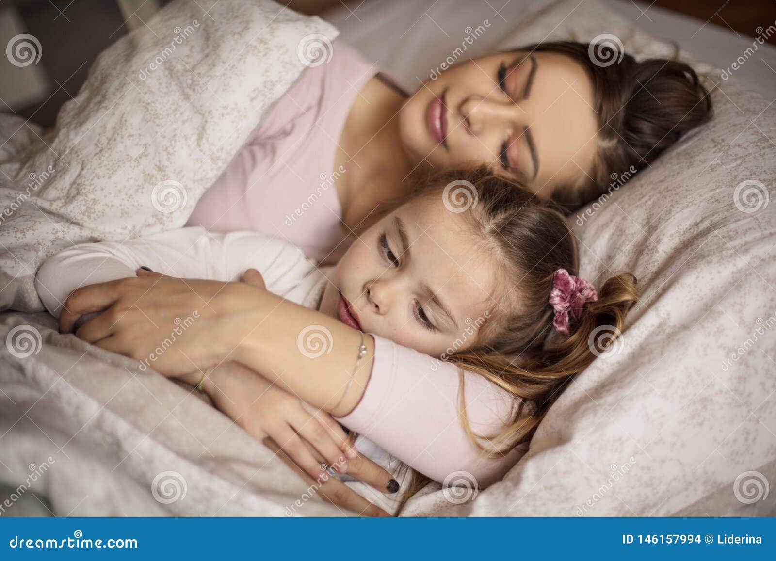 In bed next to mom