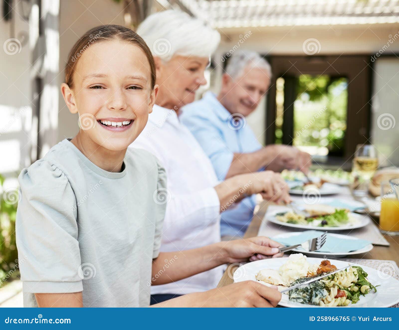 I Love Family Dinners. an Adorable Little Girl Enjoying a Meal with Her