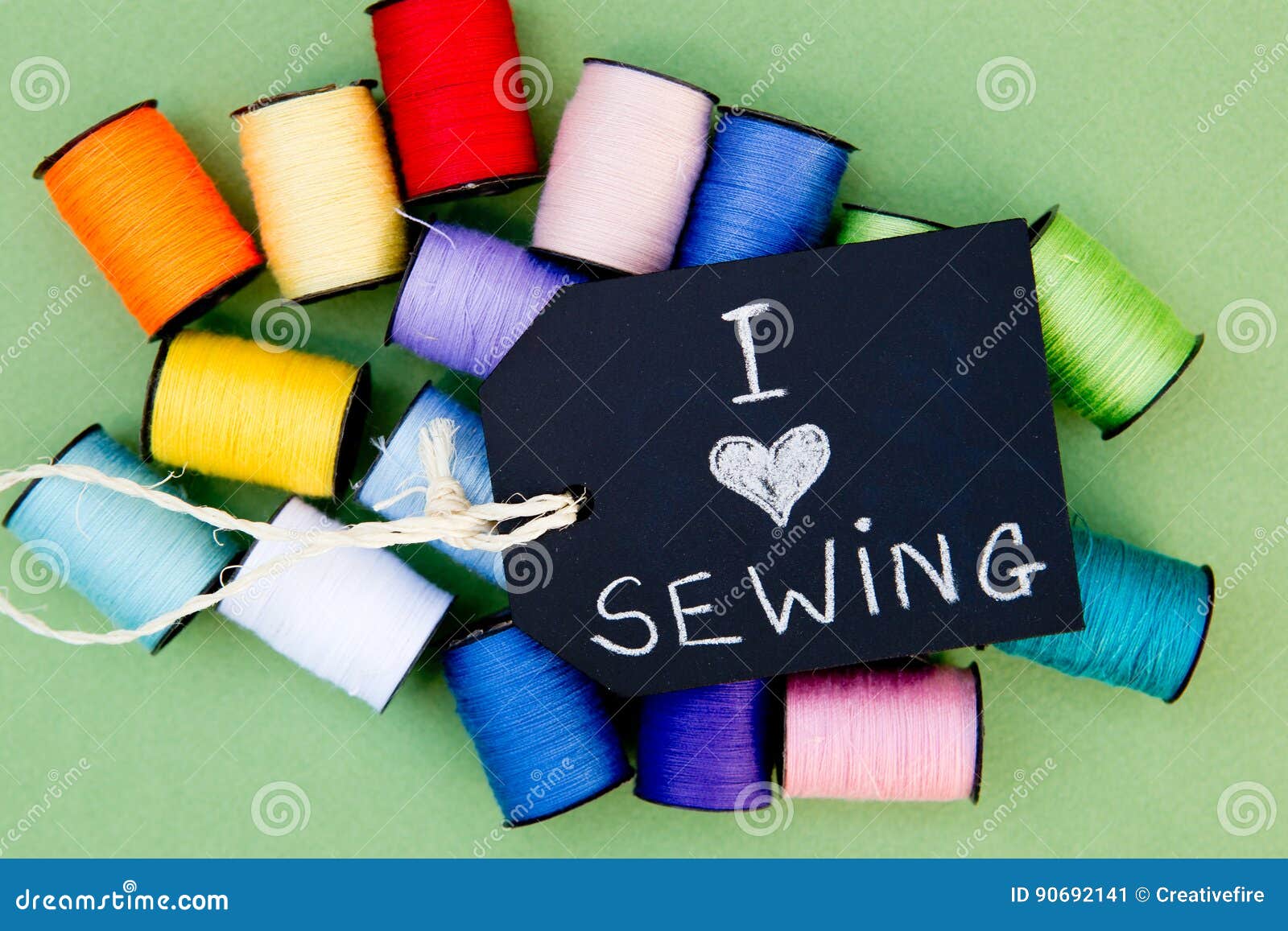 I Love Sewing - Cotton Reels Background with Blackboard Stock