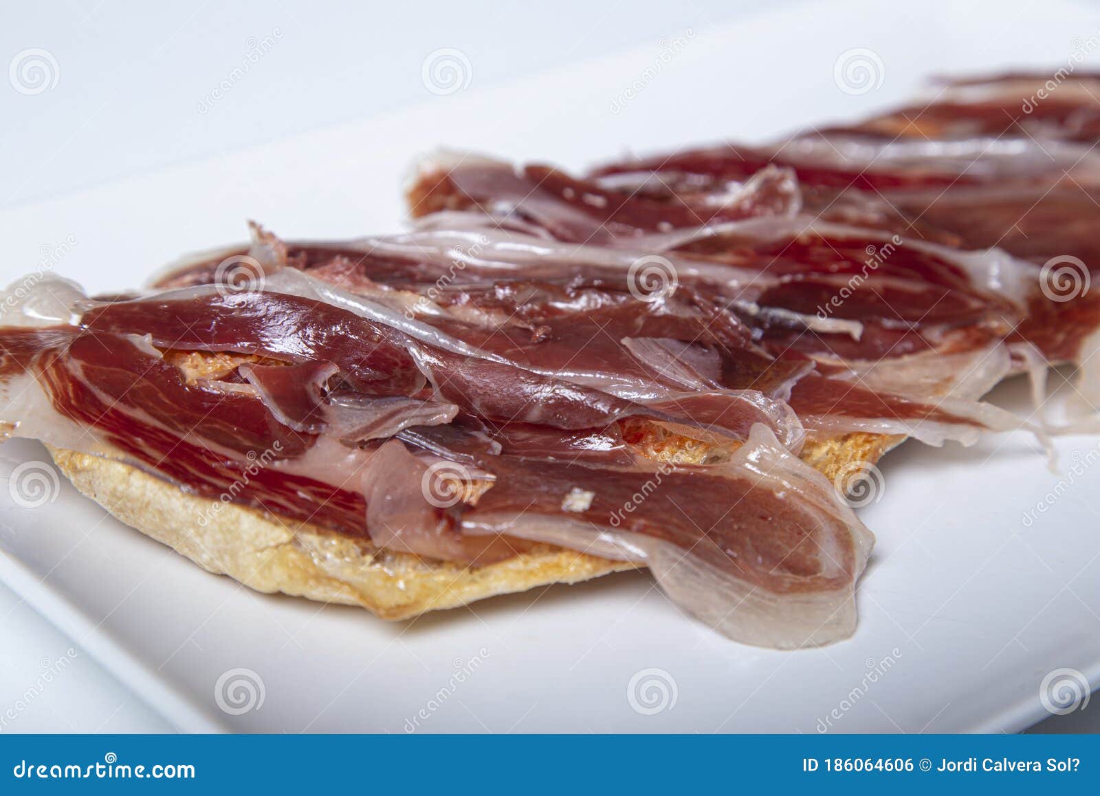 Iberian Ham Toast. Spanish Typical Food. Isolated Image Stock Photo