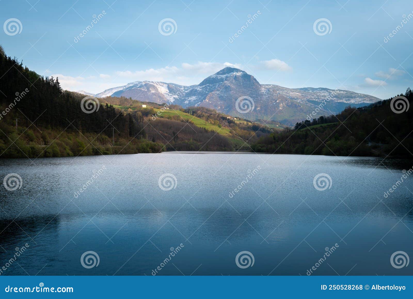 ibiur reservoir with txindoki mountain, basque country in spain