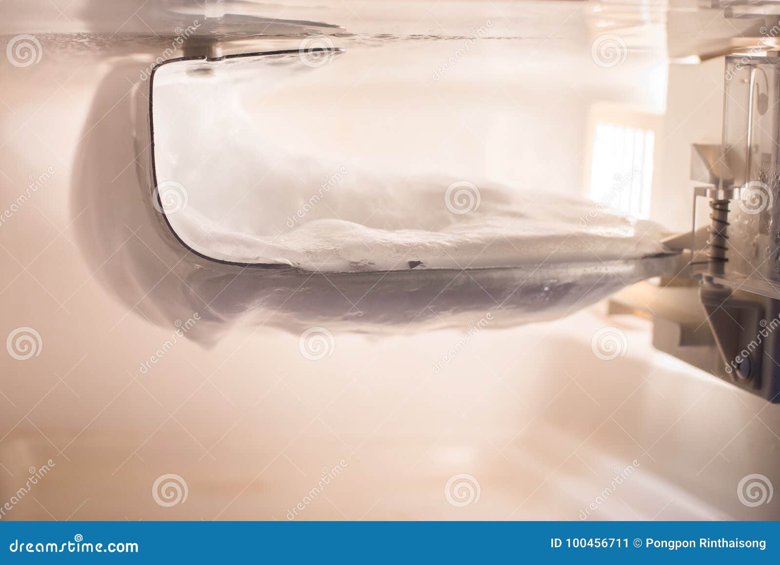 Ice Buildup on the Wall Inside the Freezer in a Small Refrigerator