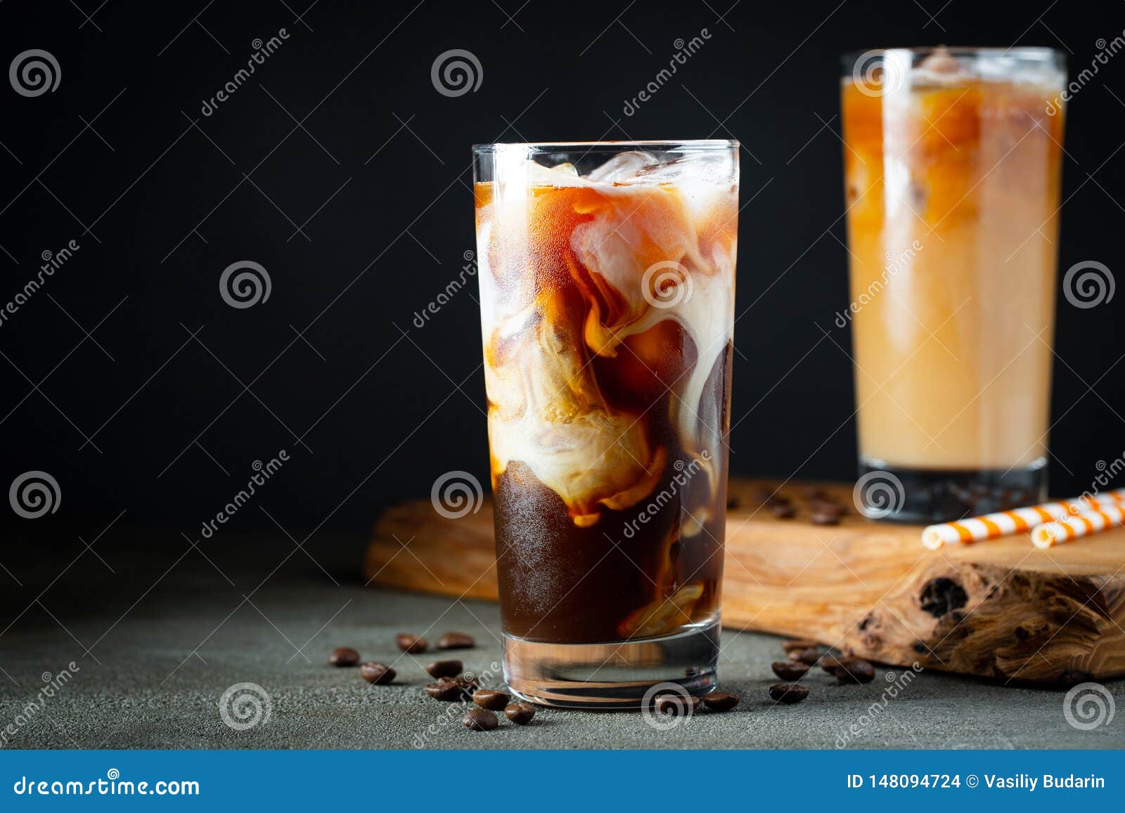 https://thumbs.dreamstime.com/z/ice-coffee-tall-glass-cream-poured-over-ice-cubes-beans-old-rustic-wooden-table-cold-summer-drink-ice-coffee-148094724.jpg