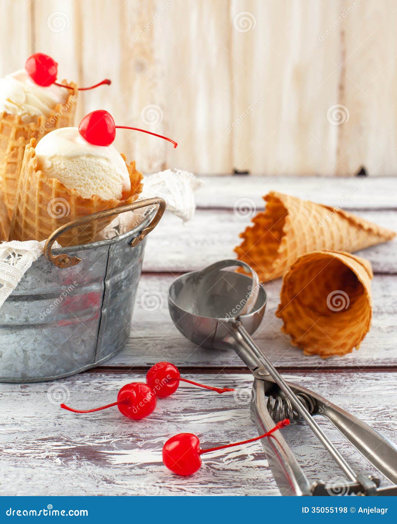 Ice cream cones with cherry in a metal basket