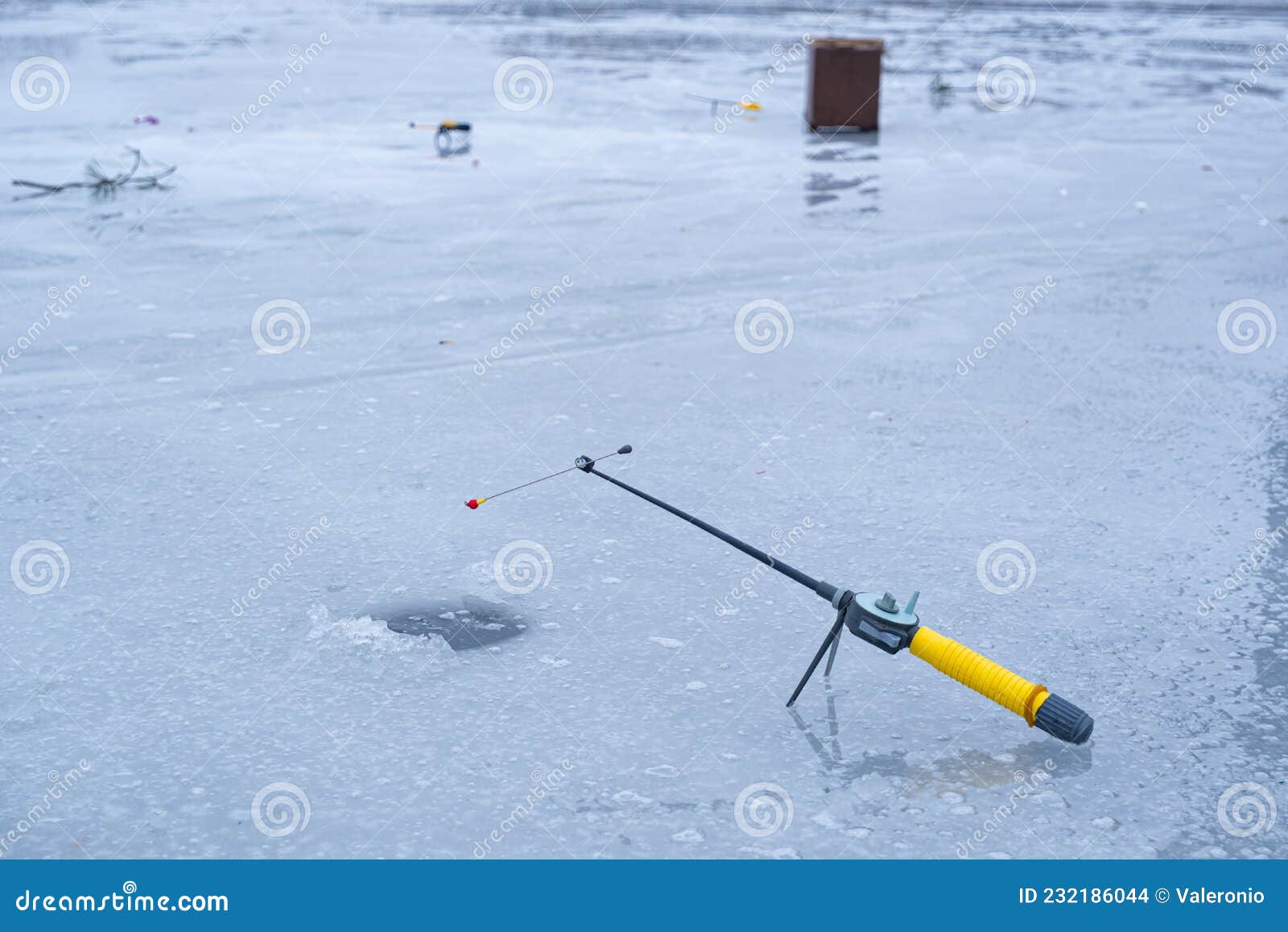 Ice Fishing Rod Ready Waiting for Fish Bite in a Hole on a Narrow