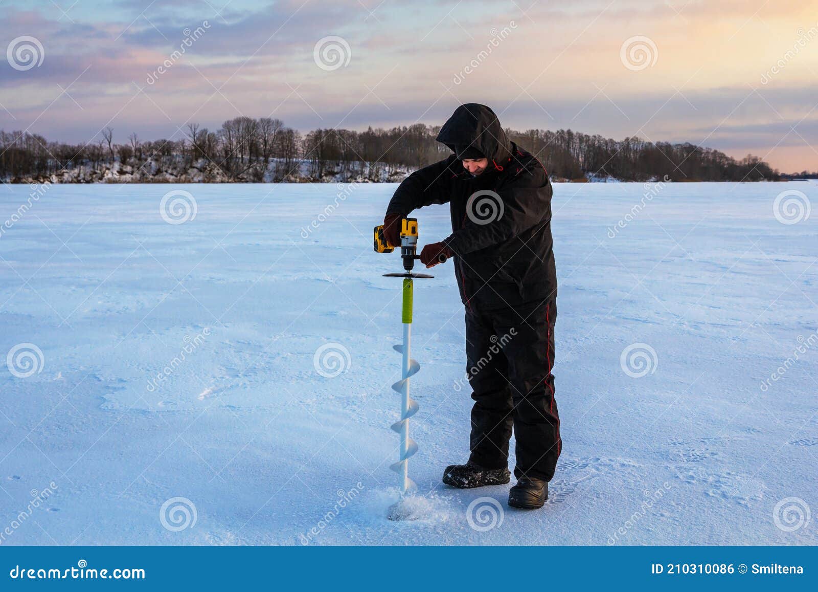 Ice Fishing Using an Electric Auger Stock Photo - Image of