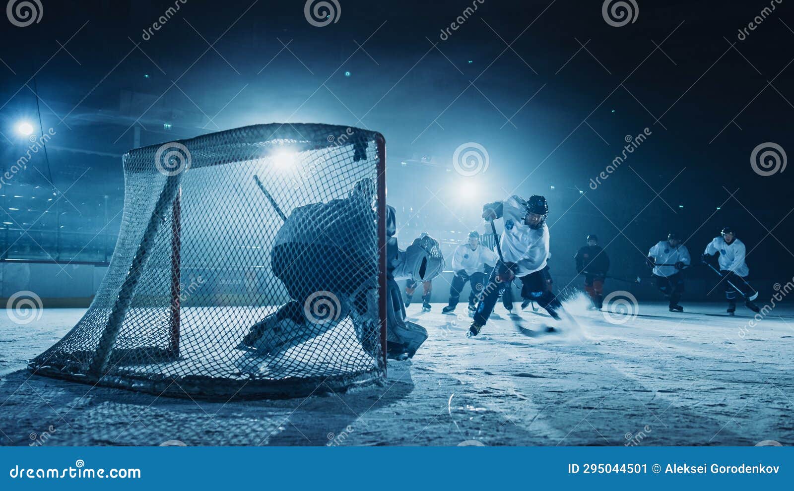 ice hockey rink arena: goalie against forward player who does slapshot, shots puck with st
