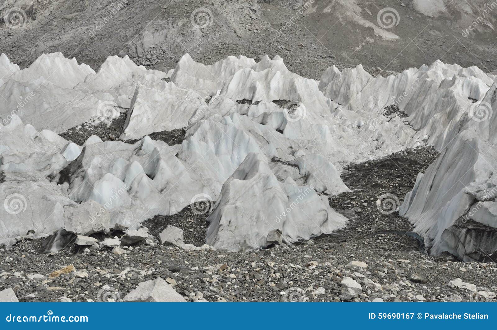 ice and stones from deep valley of khumbu glacier from everest base camp, himalaya. nepal