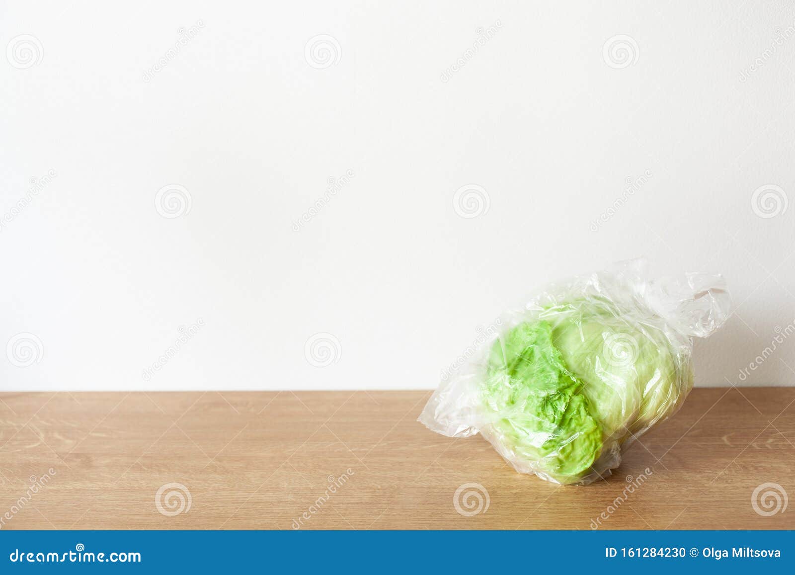Iceberg Lettuce Vegetable in Plastic Bag. Single Use Plastic Packaging