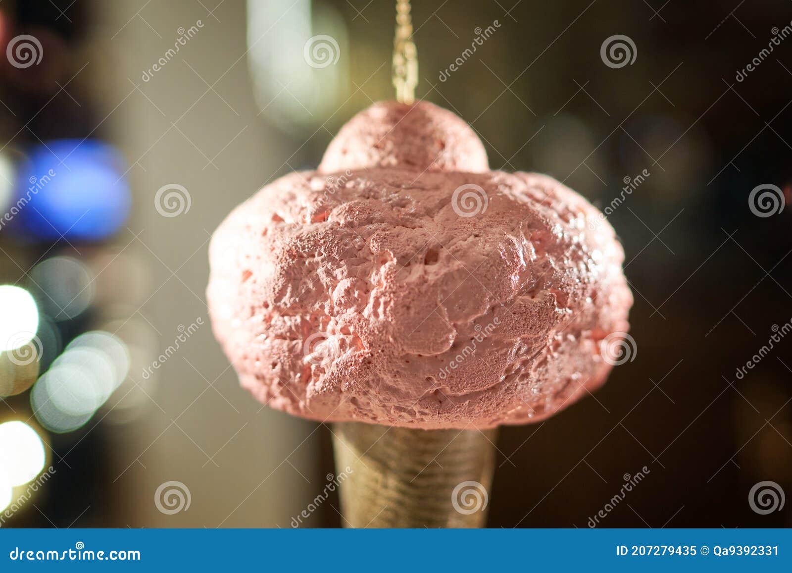 icecream cone artificial hanging on display of cafe store venchi in milan, italy. ice cream decorative background.