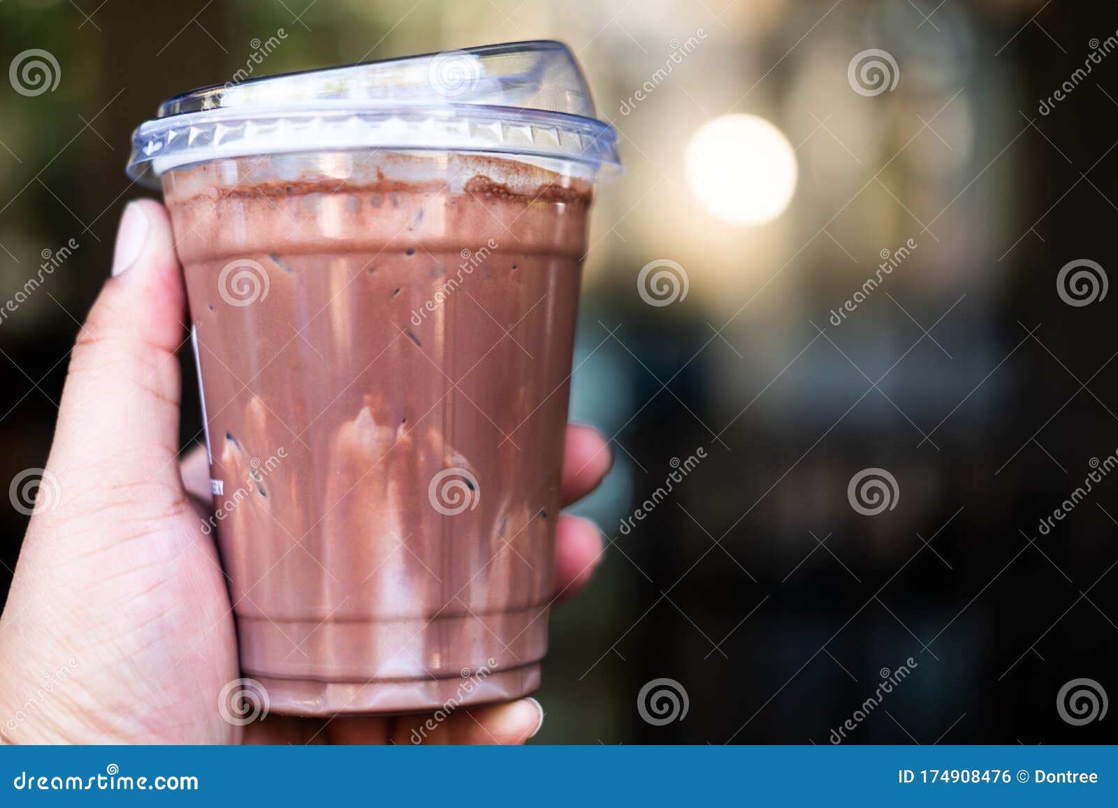Plastic cups of milkshake on color wooden background Stock Photo by  ©belchonock 82524058