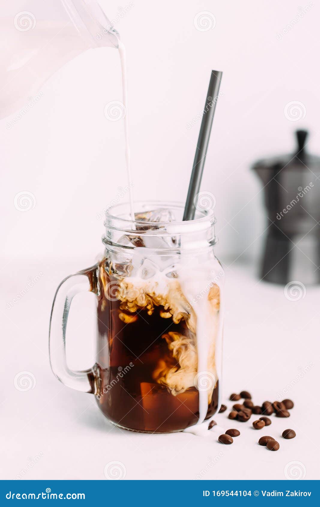 Iced coffee in jar, mug glass cup on the white table Stock Photo - Alamy