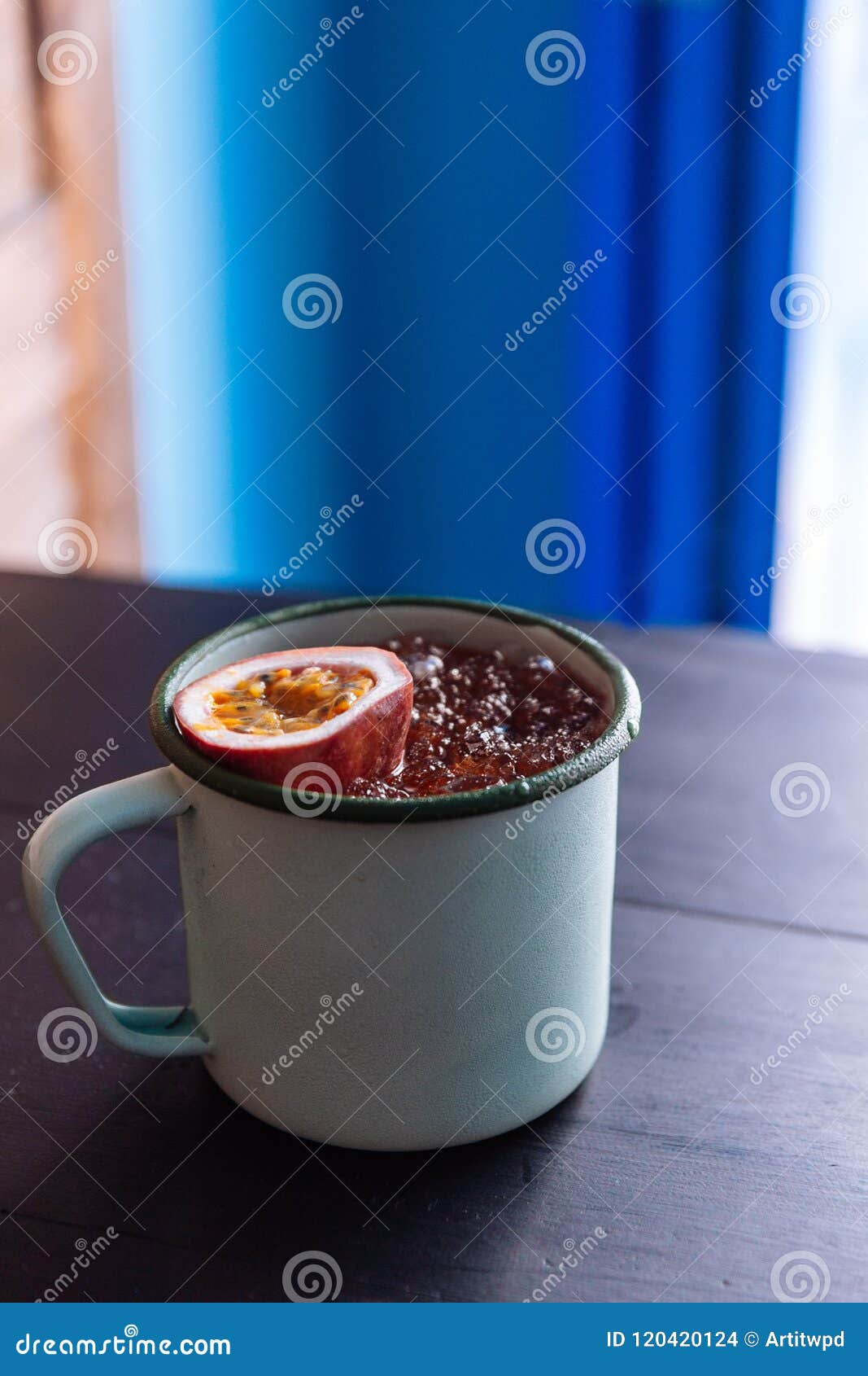 Iced Passion Fruit Juice Served in Zinc Cup with a Cut Half of Fresh