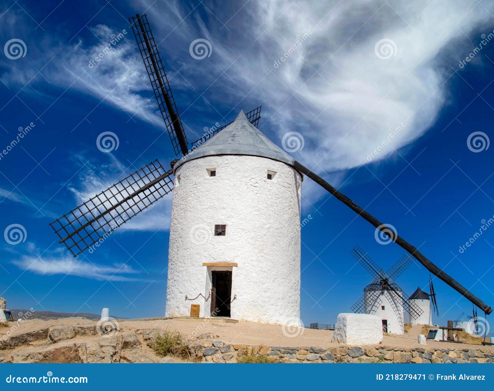 iconical view of windmills with castle in the background in europe