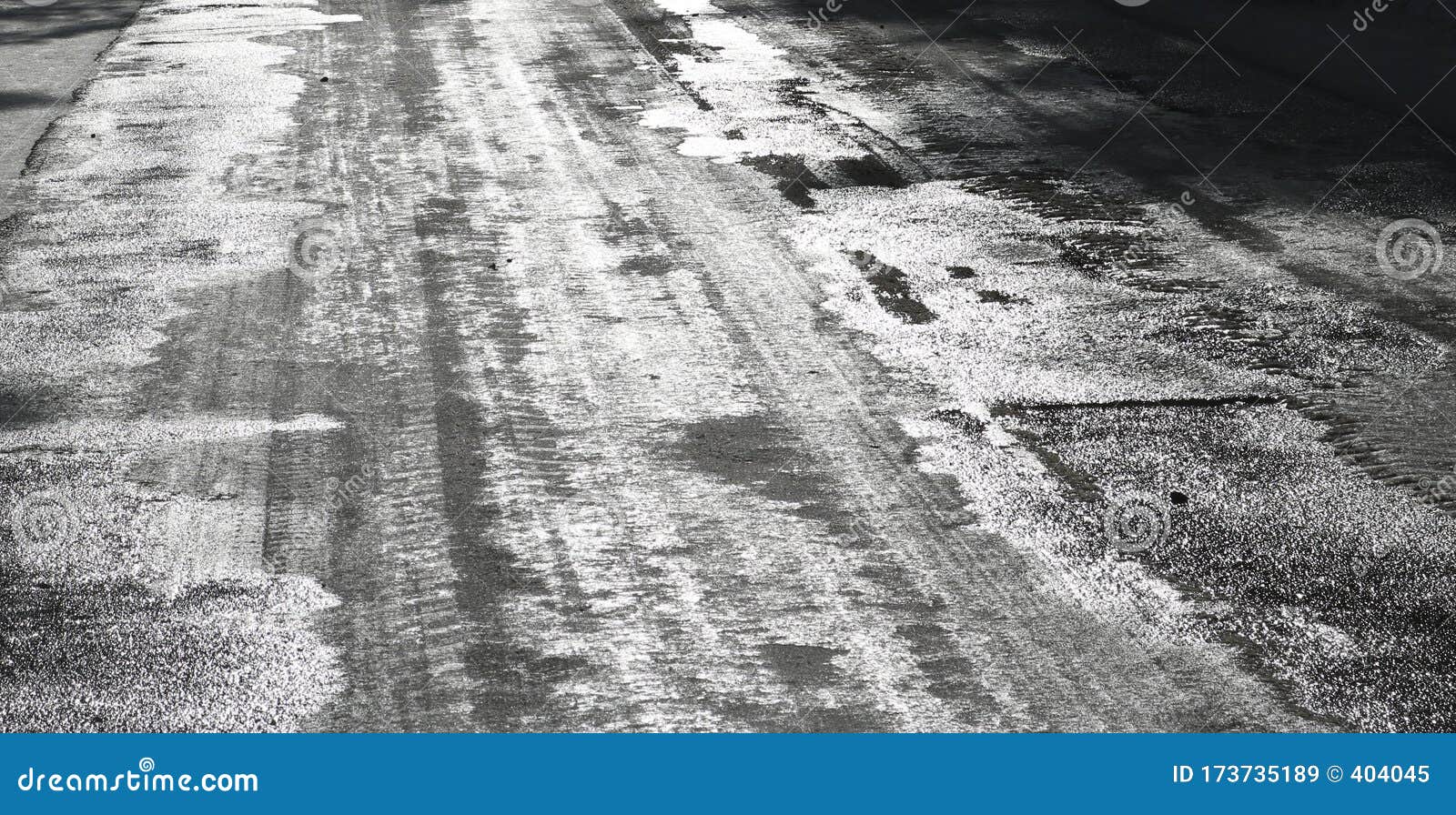 icy road. selective focus. hazard concept ice-crusted ground. black and white image