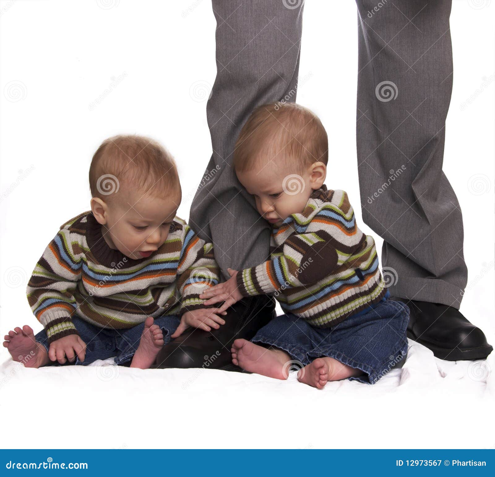 Identical Twin Baby Boys Holding Dads Legs Stock Image Image of twins