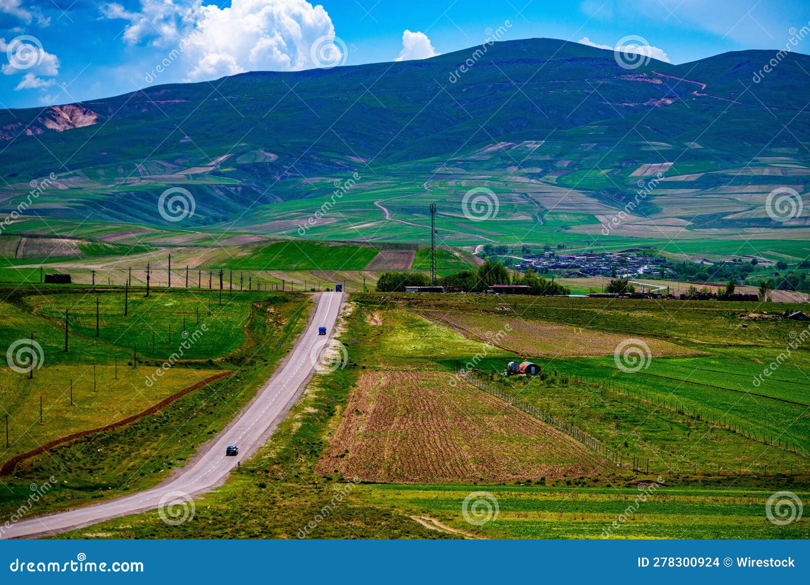 idyllic rural landscape against a vibrant blue sky in town of takab, west azerbaijan province, iran