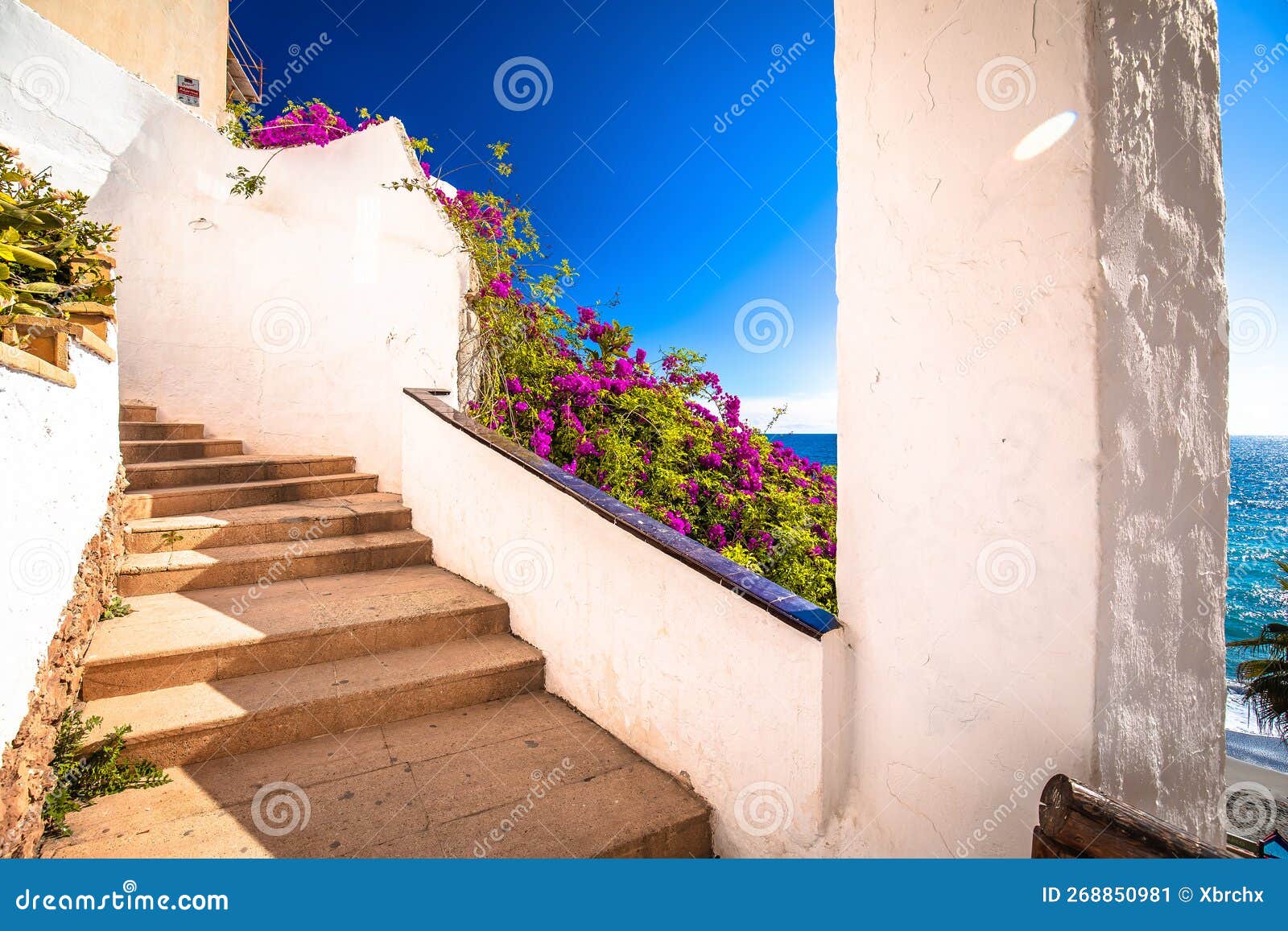 idyllic stairs to beach in nerja panoramic view