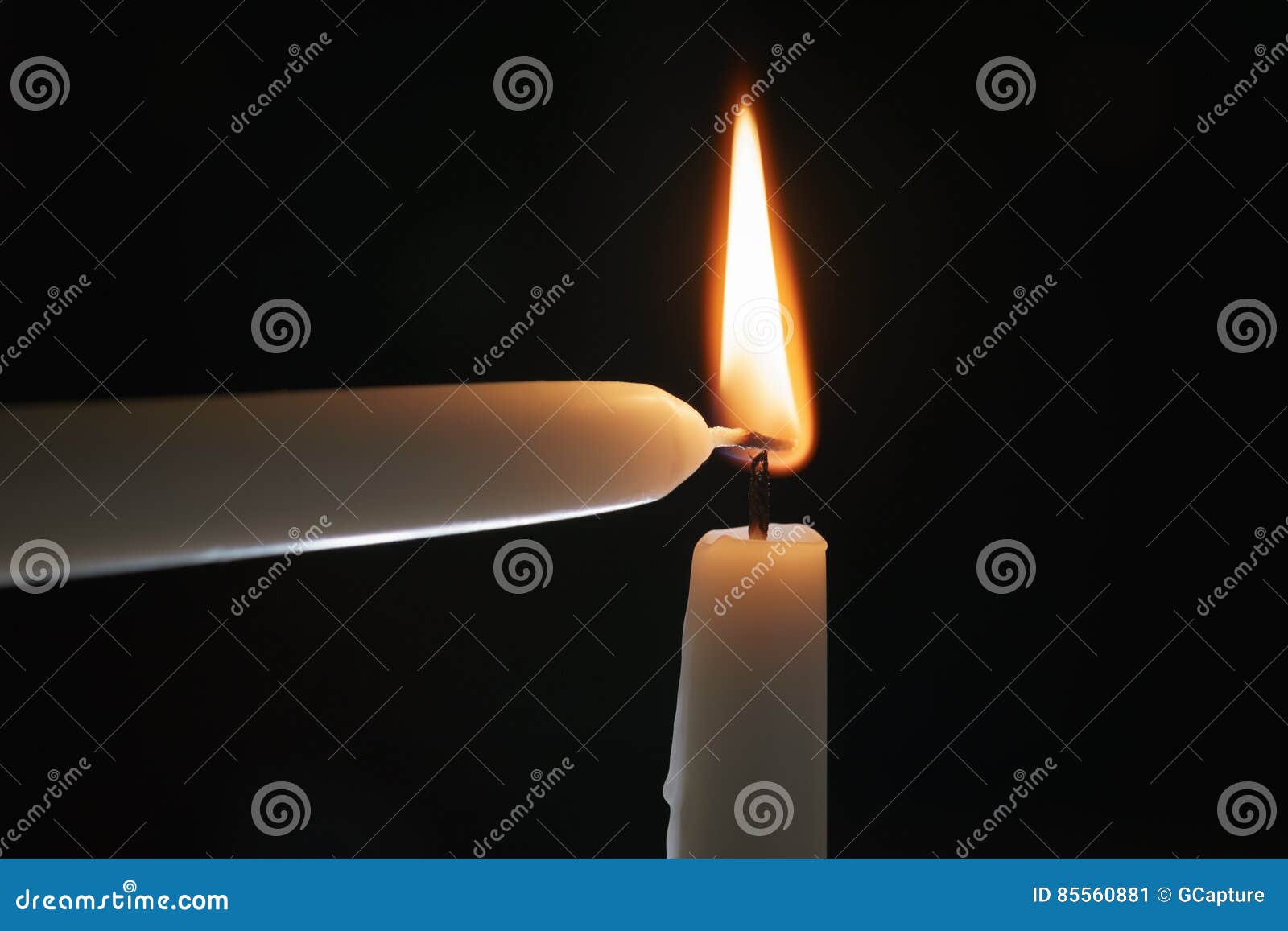 Ighting Tall Candle with Another Candle in the Dark Stock Image Image
