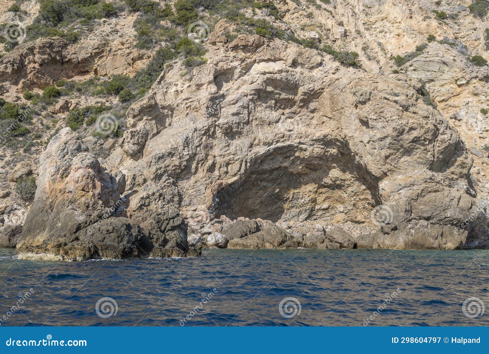 igneous rock hole in cliffs at uomo cape, argentario, italy