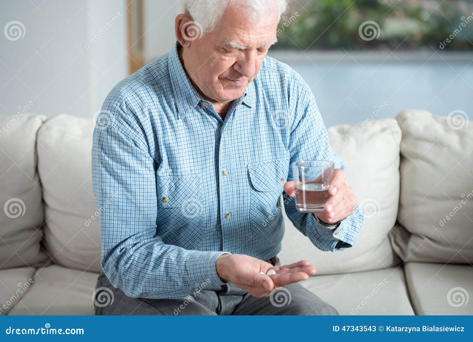 ill senior man taking pill