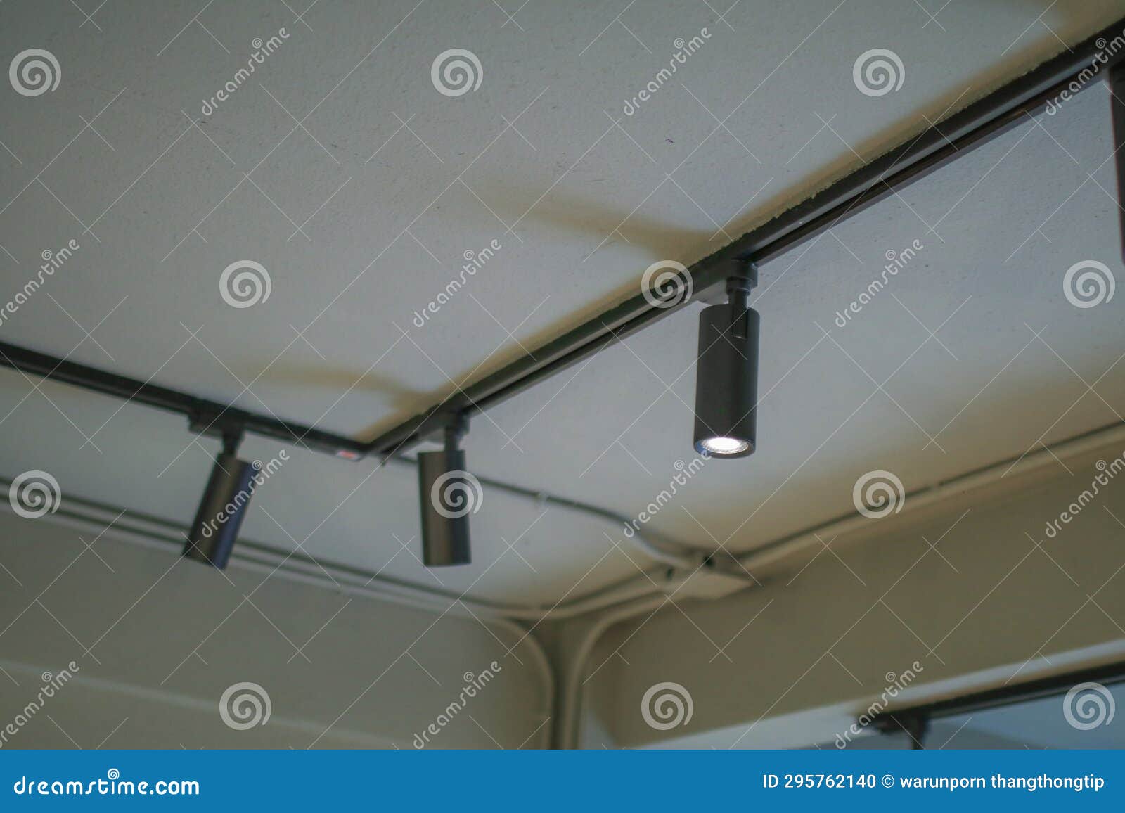 Illuminated Black Track Light on Ceiling. Modern LED Hanging Rotating