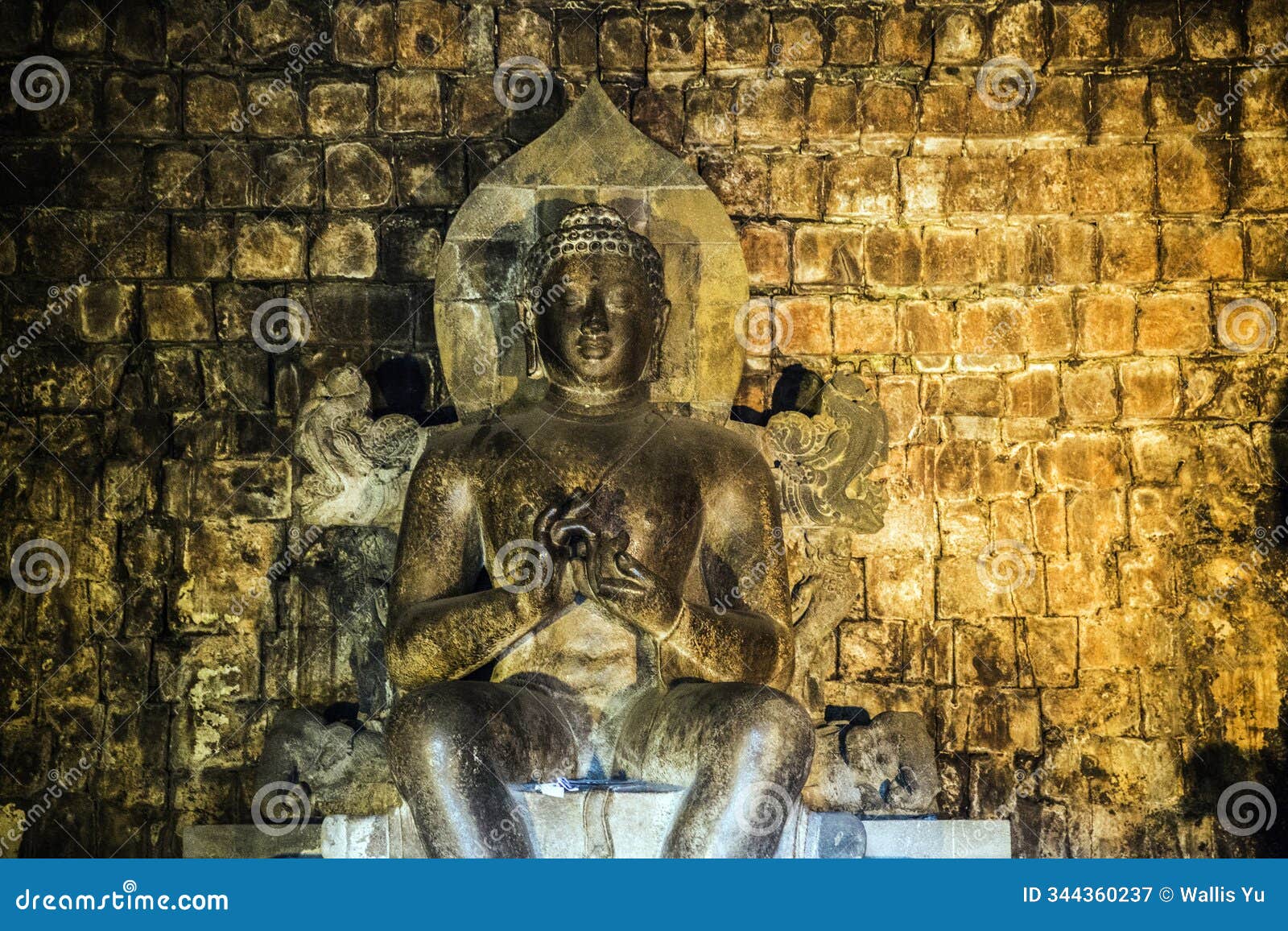 illuminated buddha statue at prambanan temple