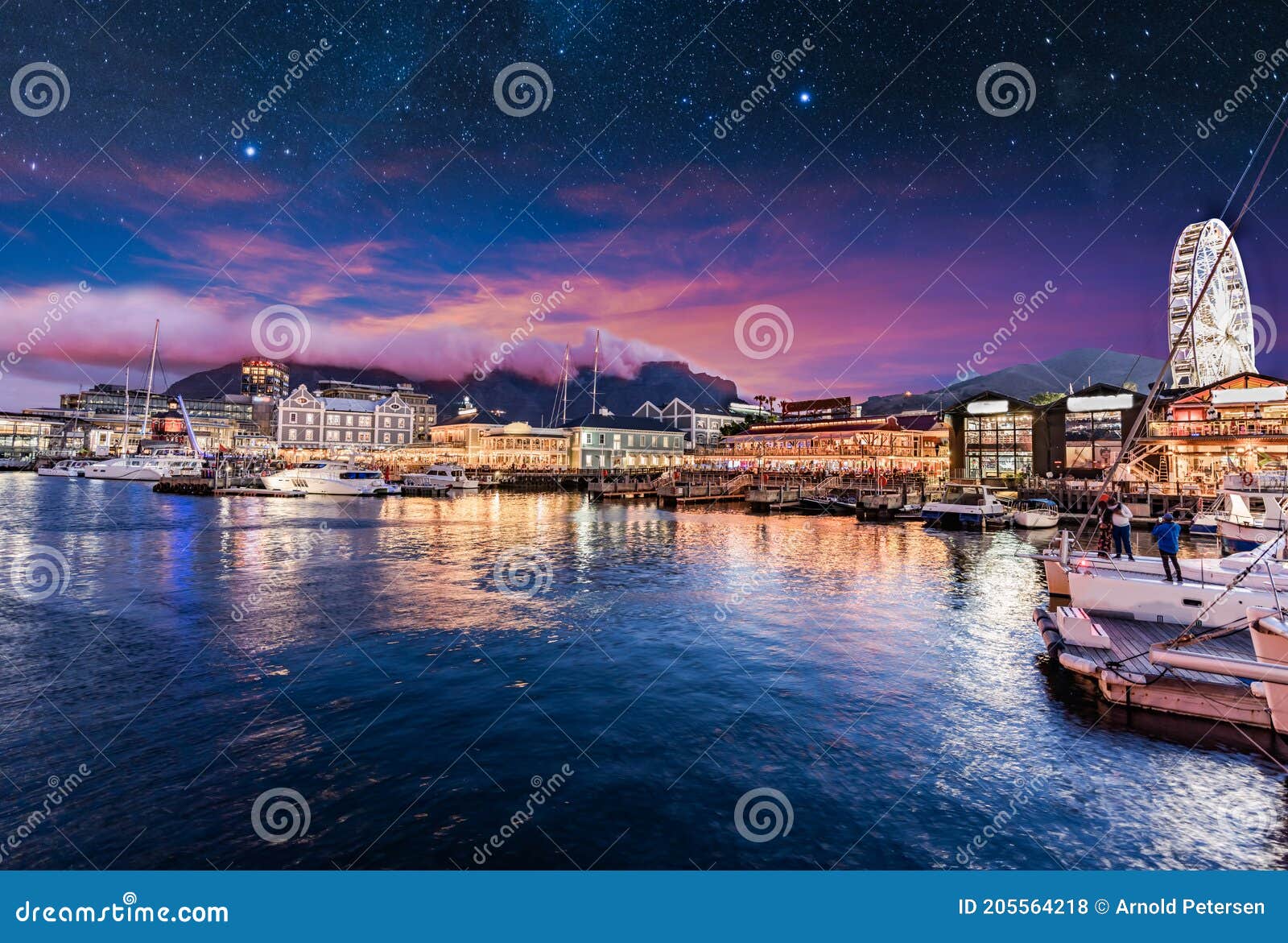 illuminated cape town waterfront at night with stars in the sky