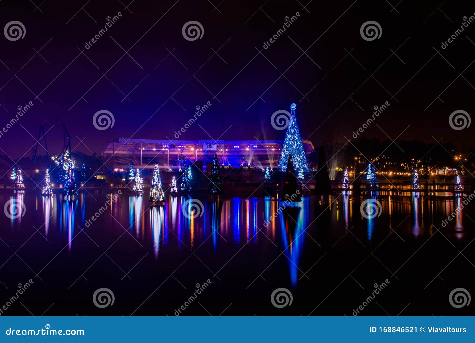 Illuminated and Colorful Sea of Christmas Trees and Partial View of