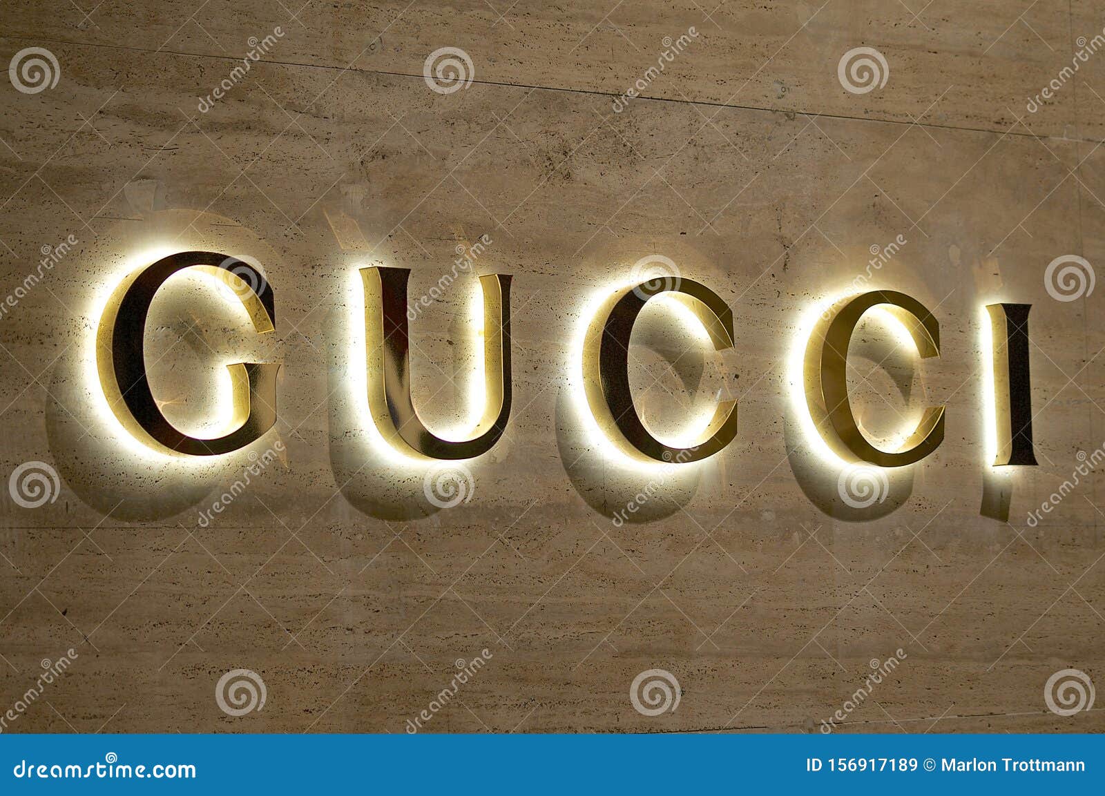 Illuminated Gucci Sign on a Marble Stone Wall Editorial Stock Image - Image  of elegant, clothing: 156917189