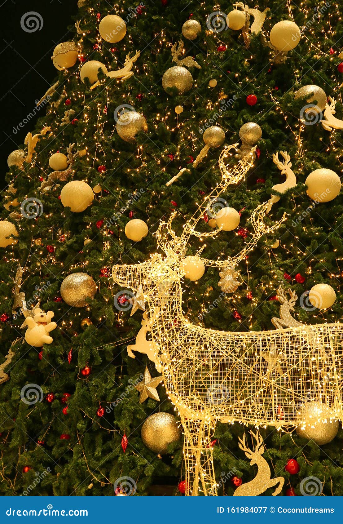 Illuminated LED String Gold Reindeer with a Big Christmas Tree in the