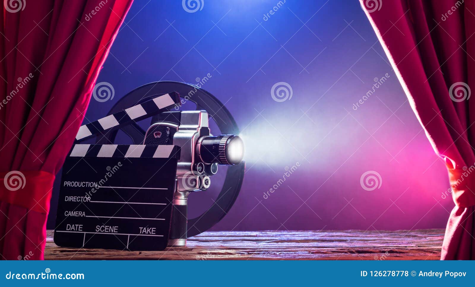 movie camera with clapperboard and film reel on stage