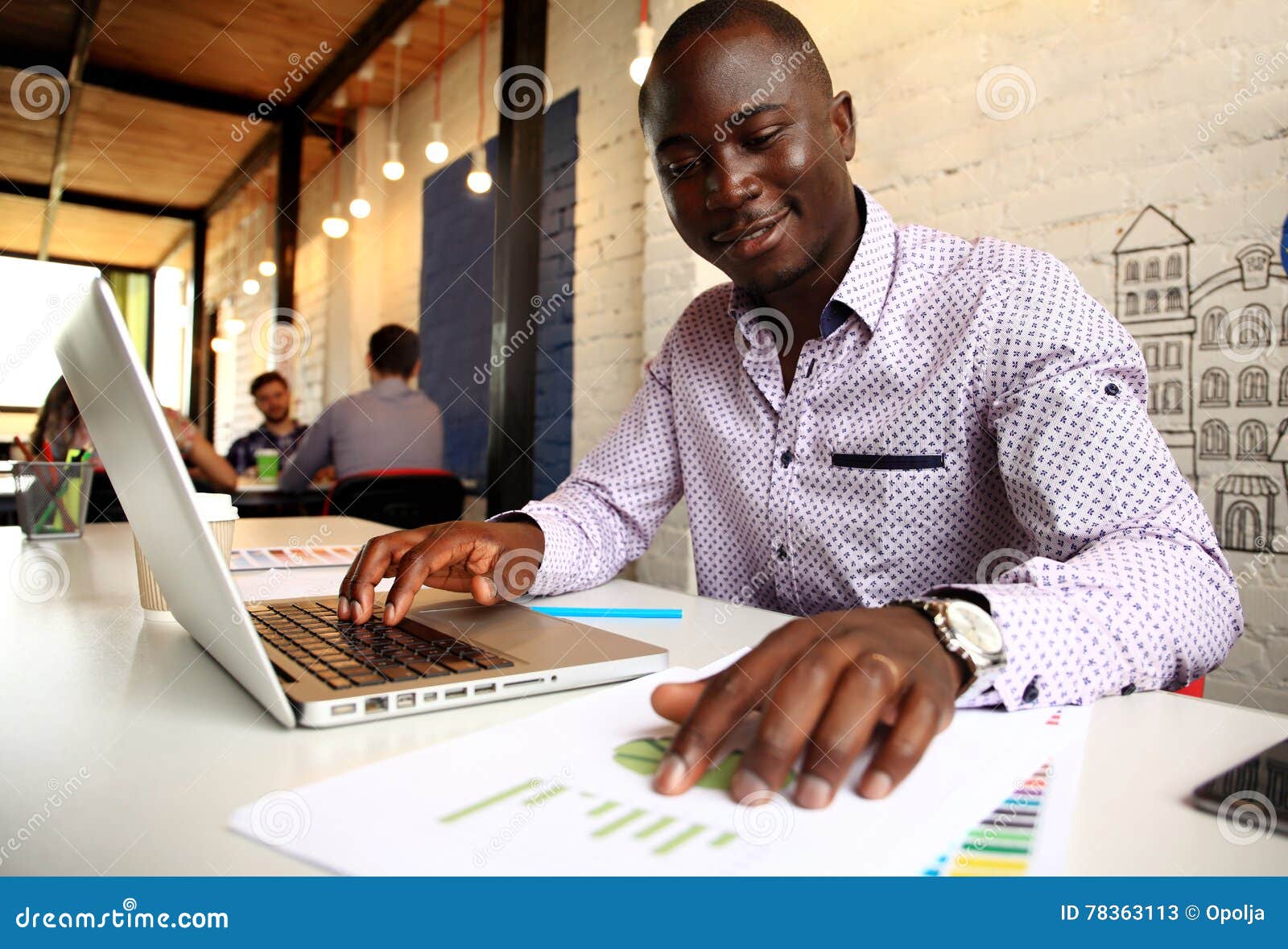 image of african american businessman working on his laptop. handsome young man at his desk