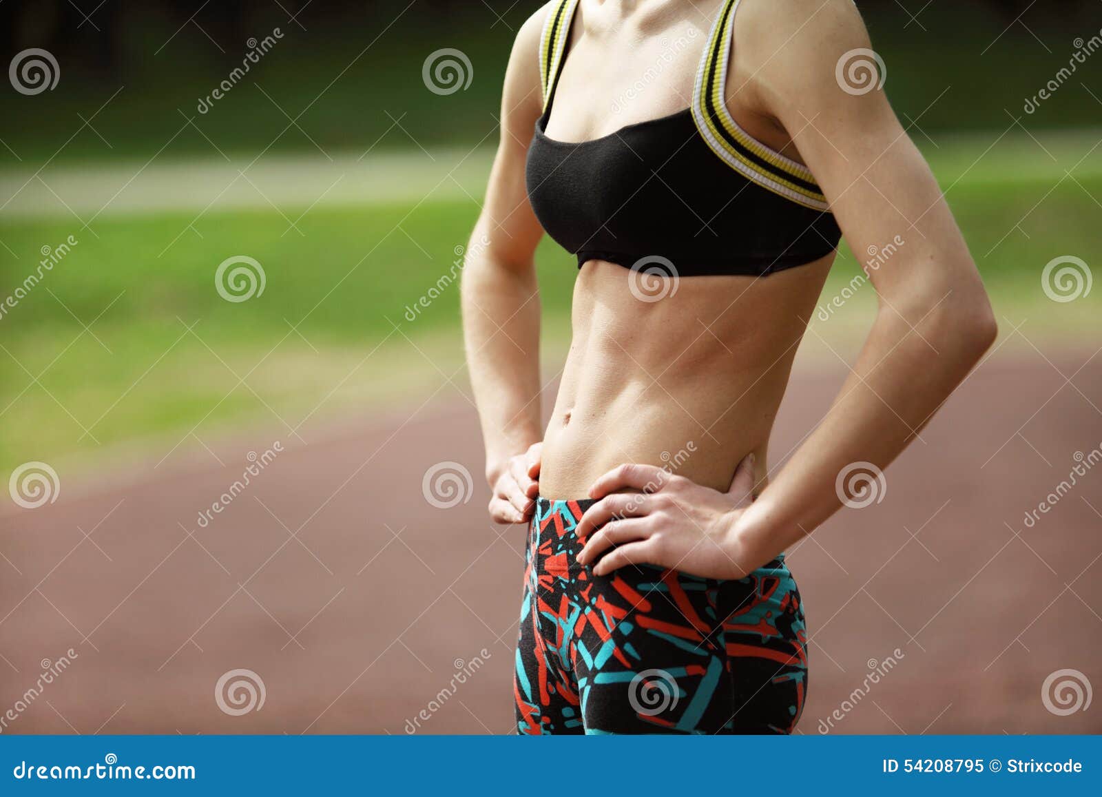 Image of Athletic Young Woman with Tight Defined Abs in Stomach Stock