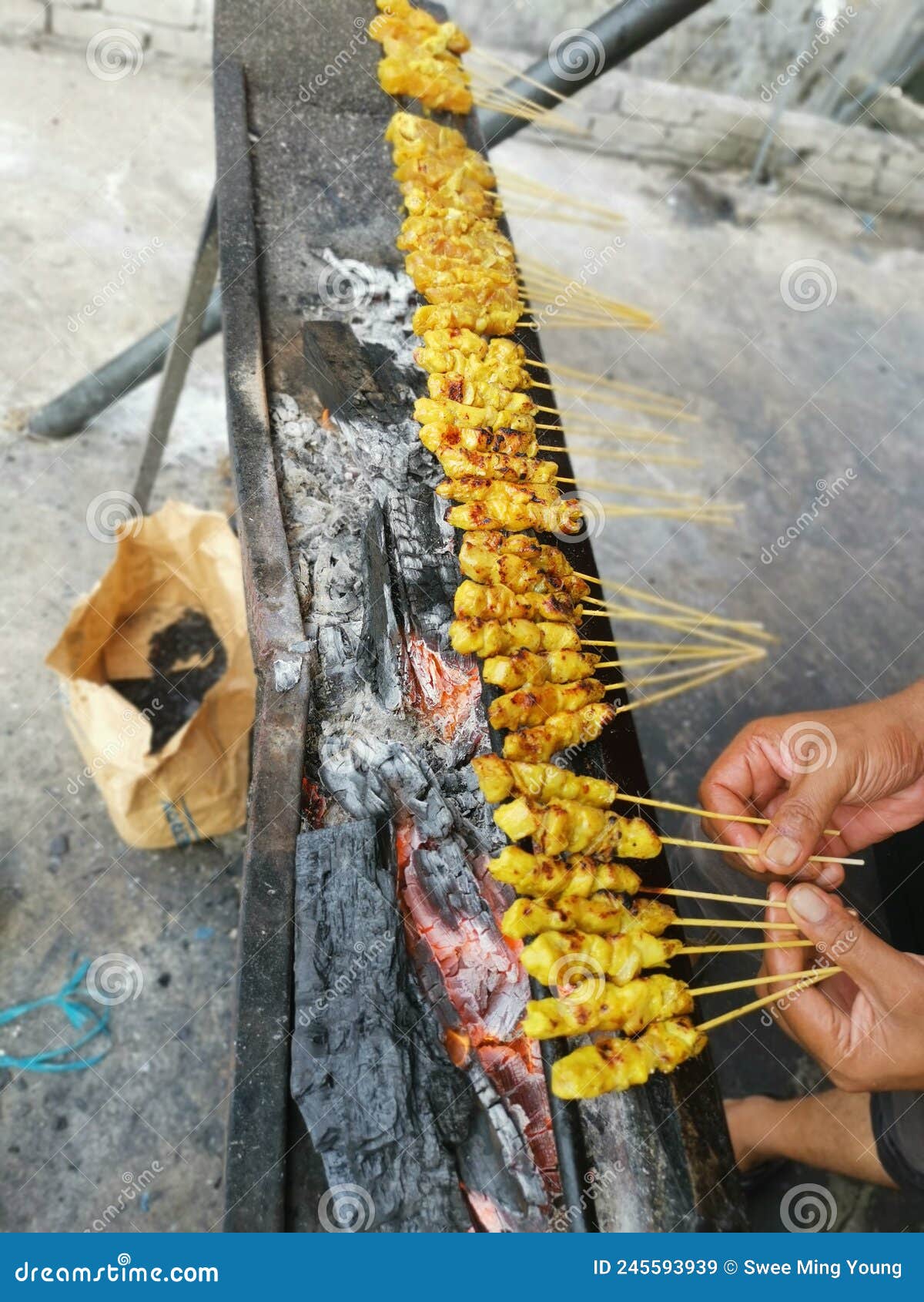 Barbecuing Sticks of Marinated and Bitesize Pieces of Chicken Meat