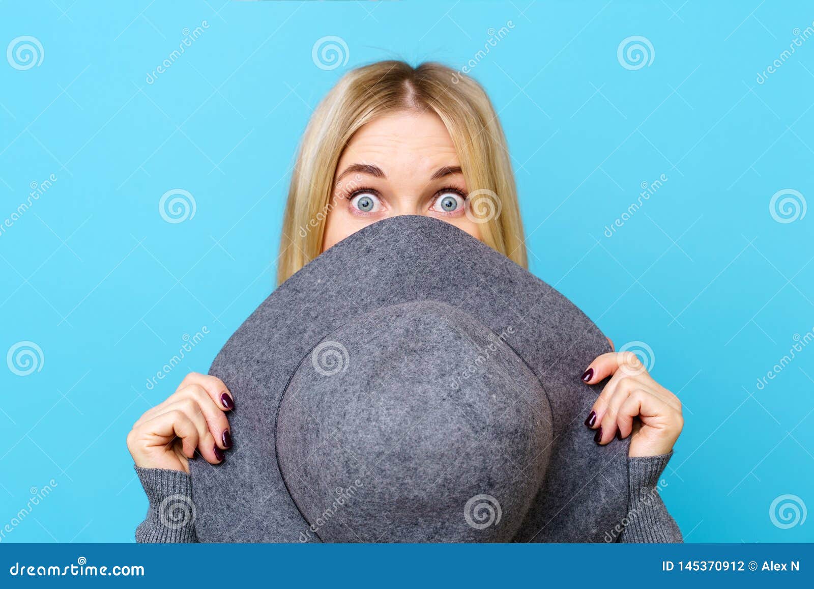 Image of Blonde Woman Covering Her Face with Hat Stock Photo - Image of ...