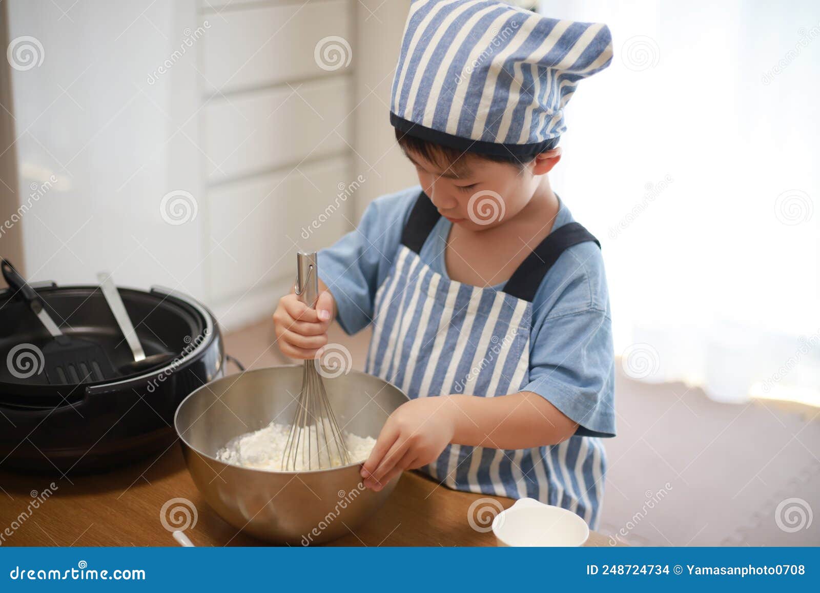 Boy making pancakes stock photo. Image of bright, helping 248724734