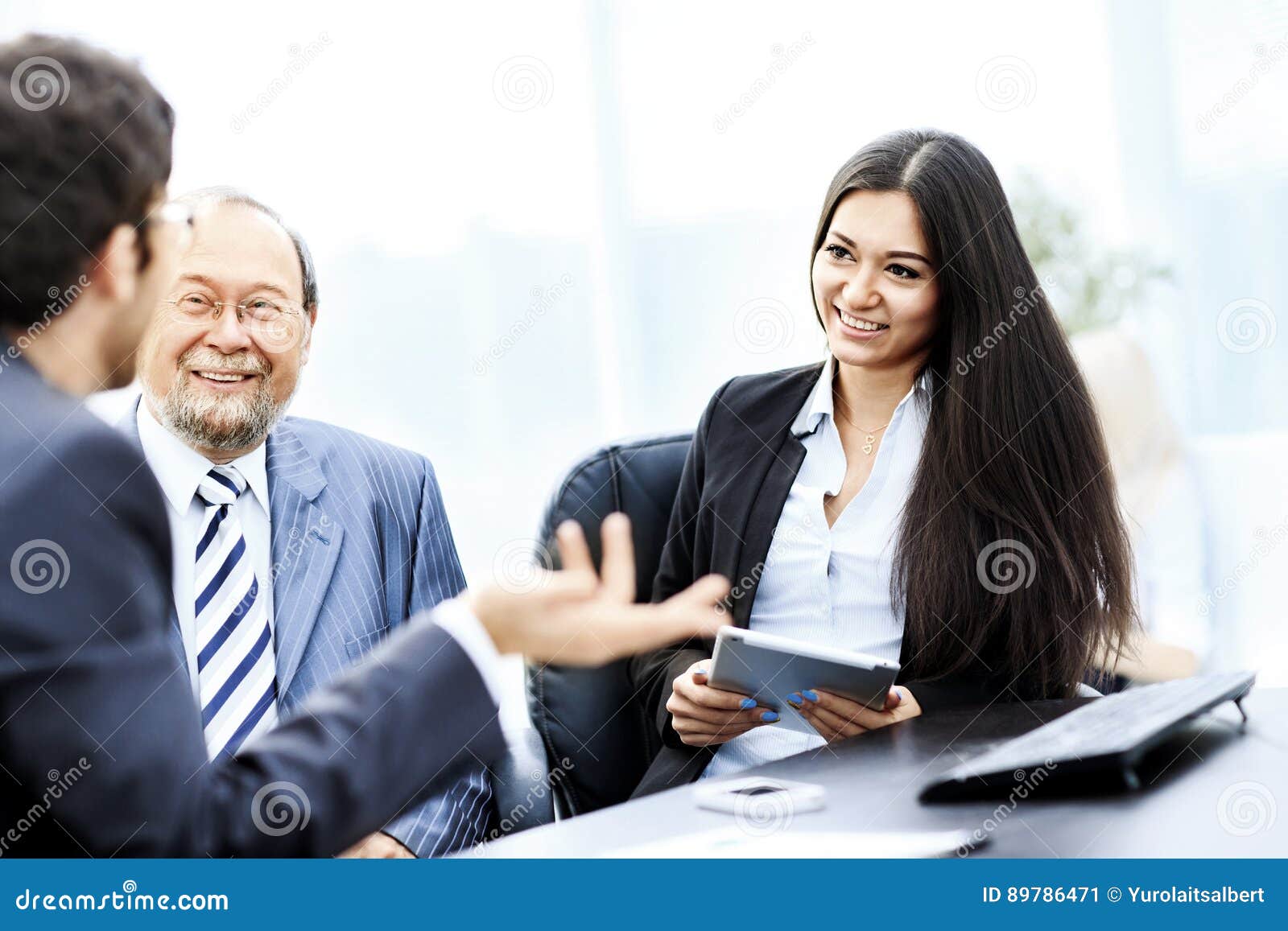 Image of Business Partners Discussing Documents and Ideas at Mee Stock