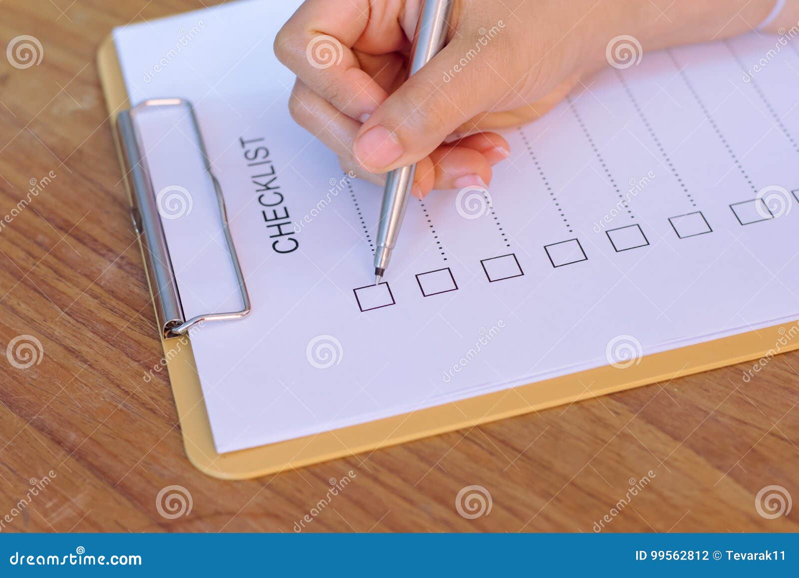 Image of Businessfemale Preparing Checklist at Office Desk Stock Photo