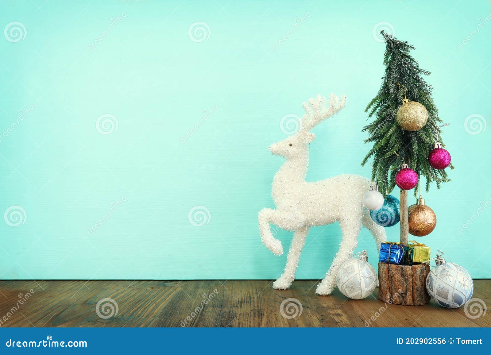 Image of Christmas Tree with Decorations and White Deer in Front of
