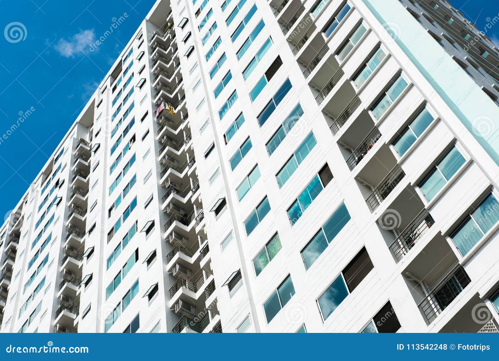 Image of Condo Building and Blue Sky Background. Stock Photo Image of