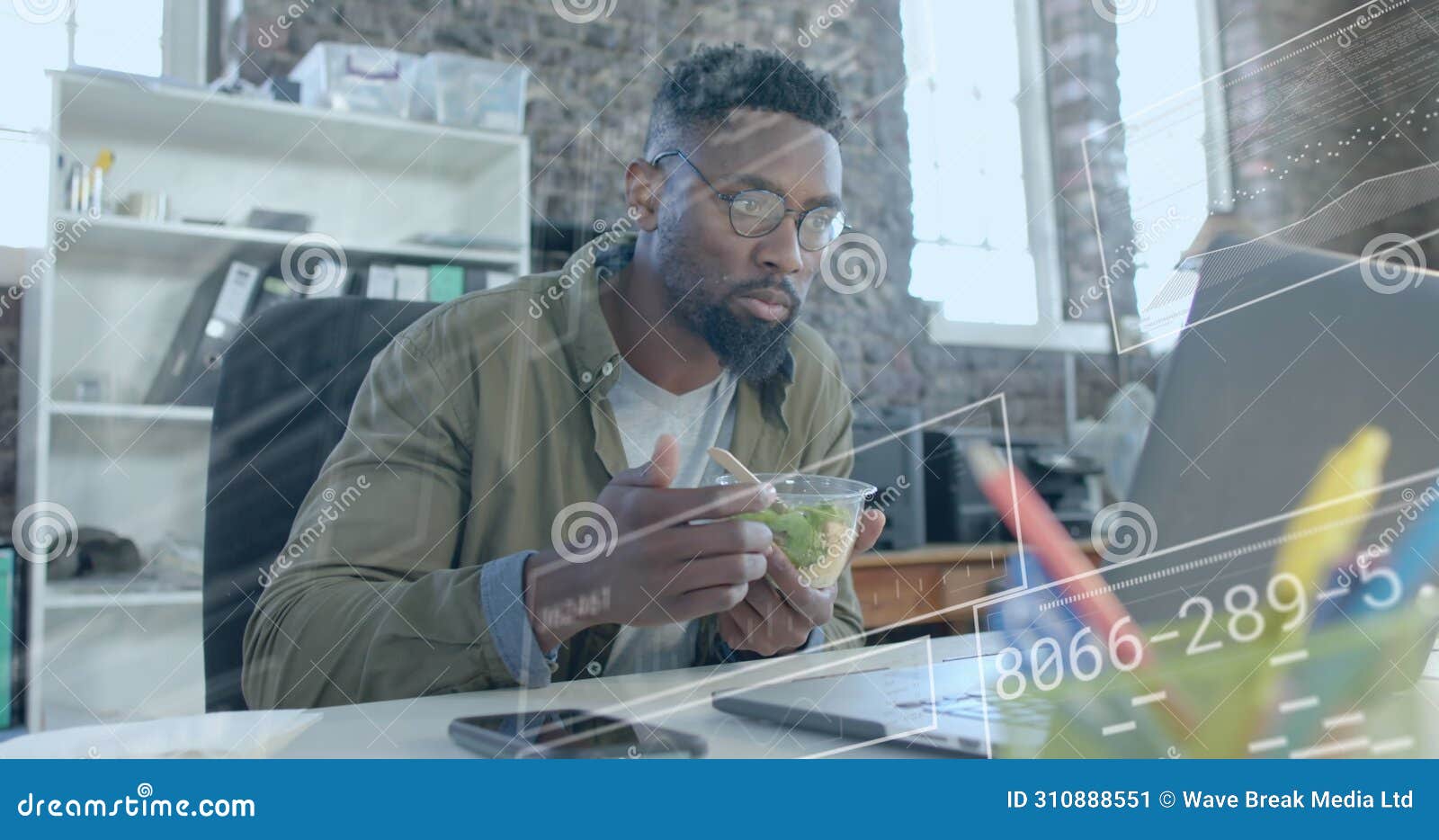 image of data processing over african american businessman having lunch in office