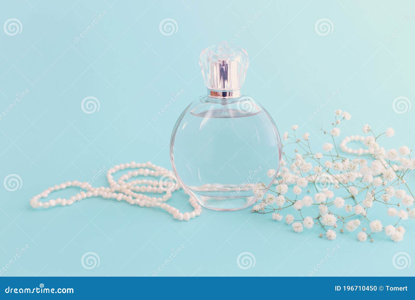 Image of Elegant Perfume Bottle Over Blue Pastel Background Stock Photo