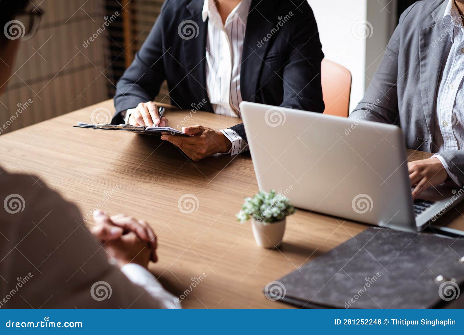 employer or recruiter holding reading a resume during about colloquy his profile of candidate