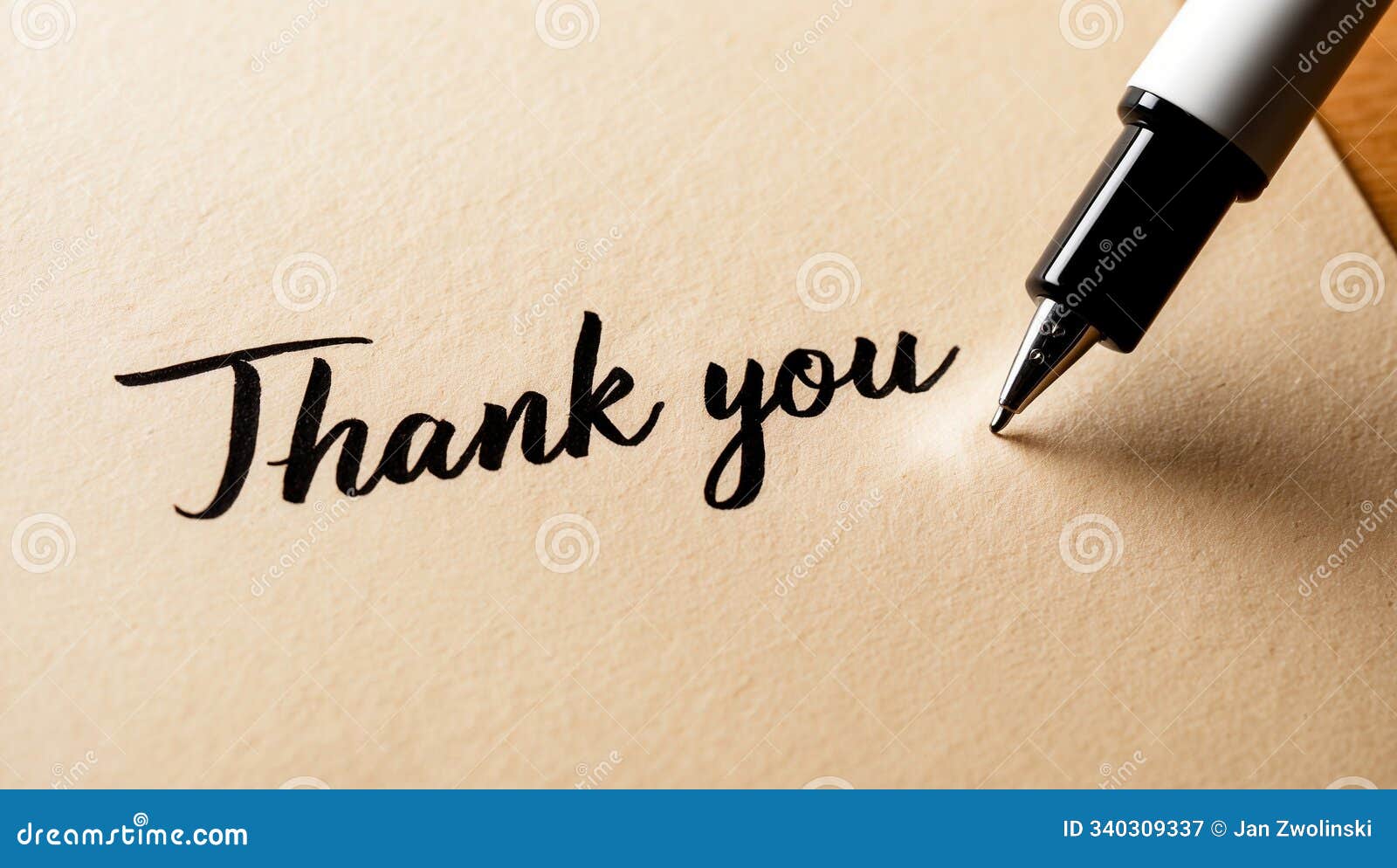 elegant black script 'thank you' with pen on textured paper background showcasing gratitude