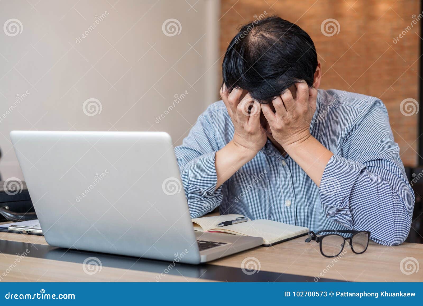 Image of Frustrated stressed business man and graph business with computer laptop in the workplace.